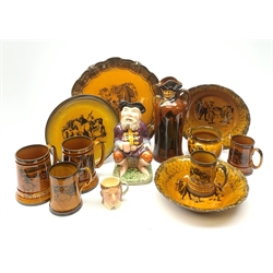 A collection of Ridgways Scenes from Coaching Days pattern pottery, comprising platter, plate, two bowls, five assorted sized tankards, and small planter, together with a Royal Doulton Kingsware Watchman Flask,, RD no 436948, a Melba Ware character jug, and a small Lancaster Toby jug. (Qty). 