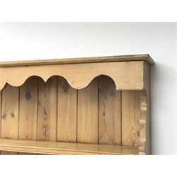  Victorian waxed pine dresser, shaped frieze above three tier plate rack with four small drawers, base fitted with single panelled cupboard and three drawers, on turned feet, W117cm, H187cm, D43cm  