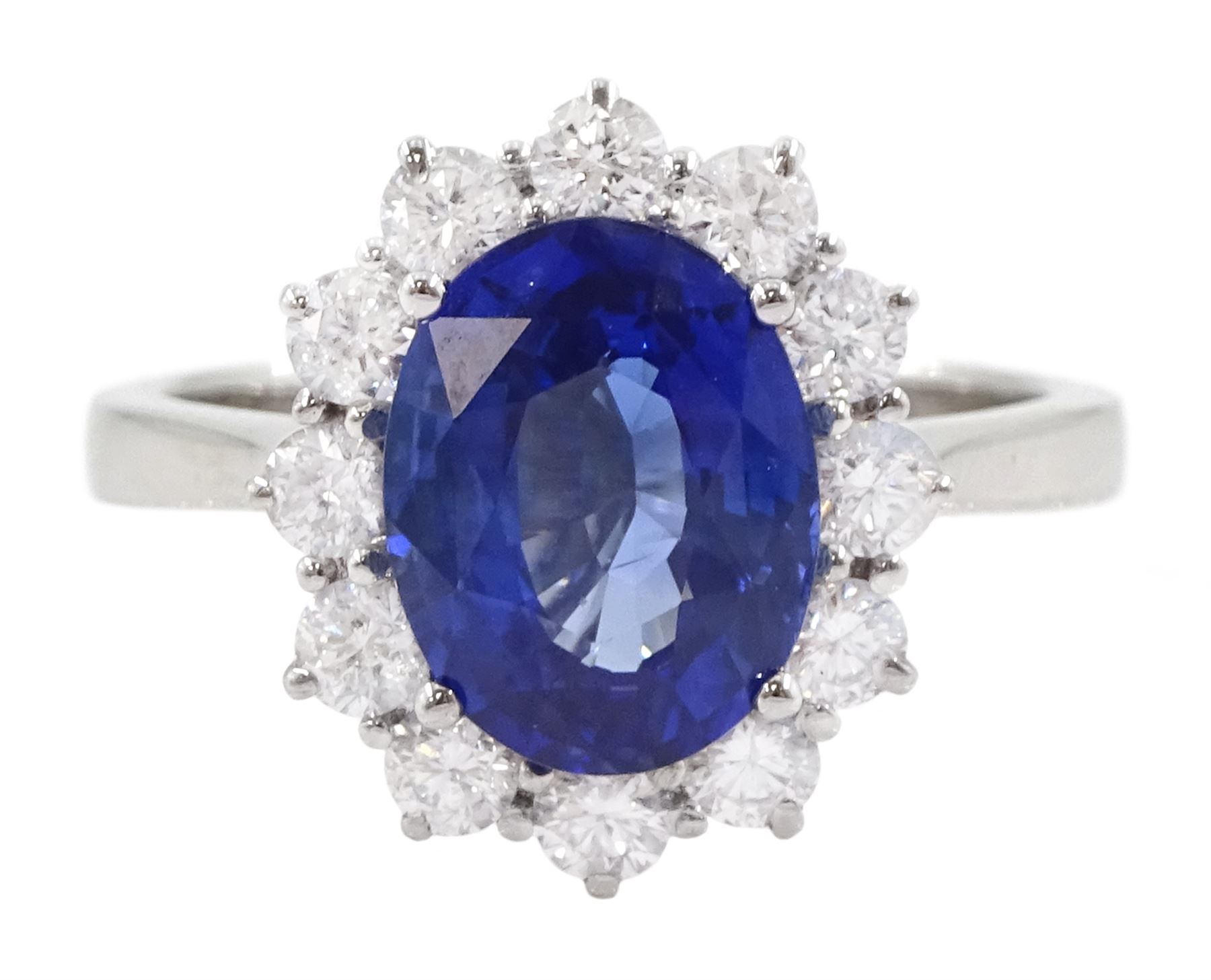18ct white gold oval cut sapphire and round brilliant cut diamond cluster ring, hallmarked, sapphire approx 3.85 carat