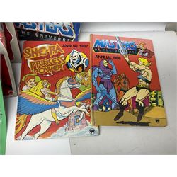 Thirty-one Masters of the Universe He-Man figures re-bagged on original backing cards;  two others lacking backing cards; boxed Modulok figure; bag of weapons and accessories; Roton, two horses and two battle cats; 1986 & 1987 Annuals; Ladybird and other story books; Panini sticker album; instructions etc