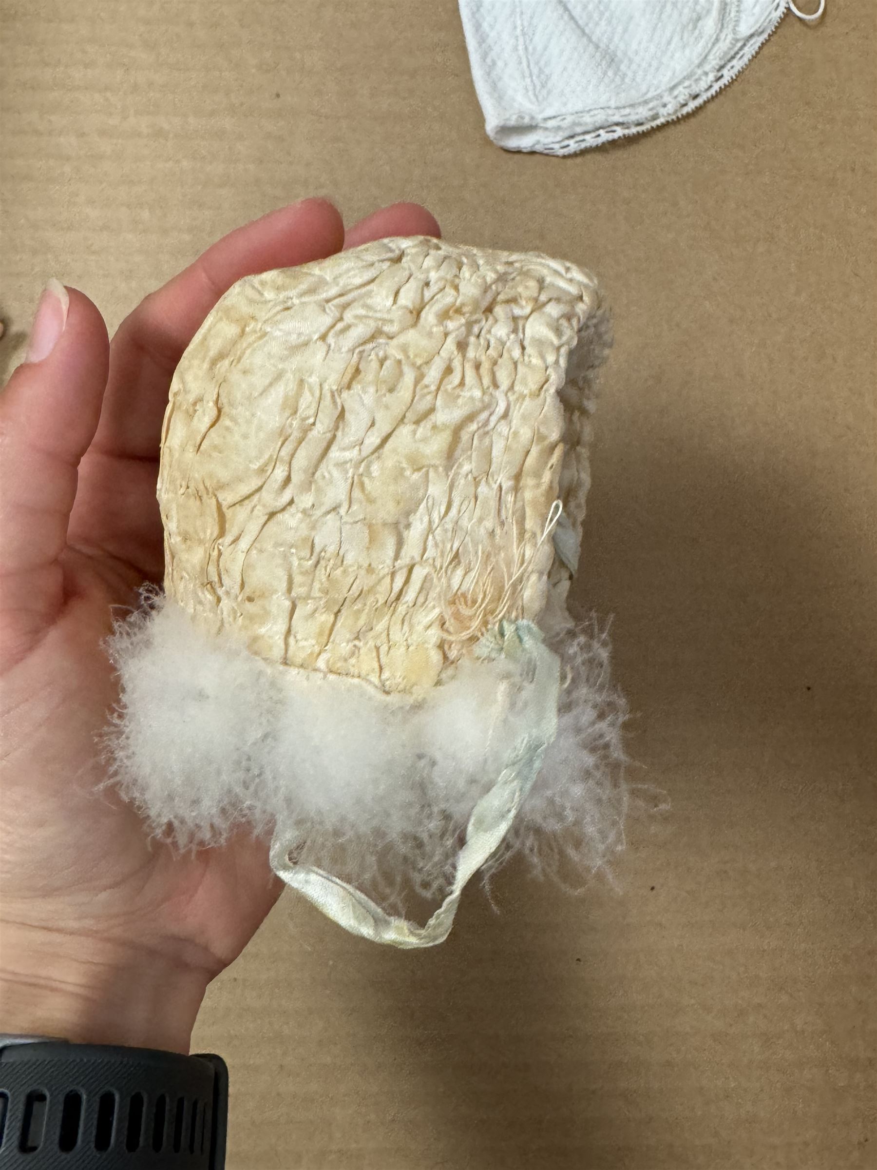 Two German bisque head dolls, to include a Franz Schmidt example with blue glass eyes and an Armand Marseille 590 example with applied hair, together with a Schoenau & Hoffmeister bisque doll's head, pair of doll's hands and a collection of clothing