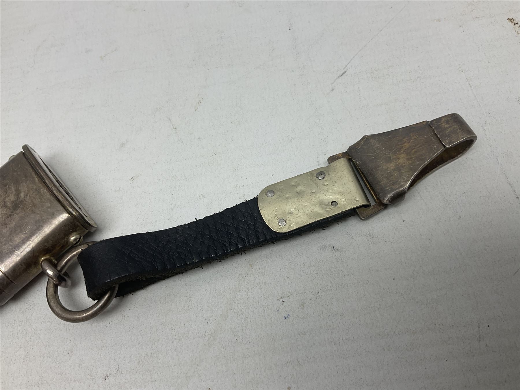 German Paul Weyersberg & Co Solingen DLV flyers dagger with 18cm steel blade, plated brass/tombac downswept cross-piece and pommel and leather covered grip, in leather and plated brass/tombac scabbard with leather hanger strap and silvered knot L35cm overall. Auctioneer's Note: After WWI Germany was forbidden an air force by the Treaty of Versailles however the Deutscher Luftsport-Verband (German Air-sport Association) was formed in March 1933 from various sports flying clubs and had branches for aeroplane, gliding and balloon flying. Under cover of the sporting DLV, many future Luftwaffe pilots trained to fly. DLV was embodied with the NSKK in March 1935 and on 1st March 1937 Luftwaffe was formed.