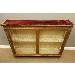  Pair of 19th century gilt wood and gesso display cabinets, top with velvet cover above projecting egg and dart decorated cornice above arcade frieze with stylised motifs, two lglazed doors enclosing damask lined interior, on cast and gilt metal front feet and collar turned rear feet, W154cm, H119cm, H32cm, (2)  