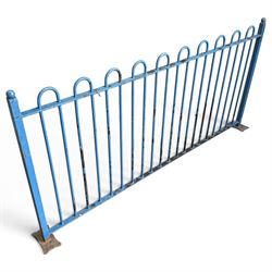 Two sections of painted iron garden or estate boundary railing, comprising a 19th century wrought iron section with graduated spearhead uprights, together with a later hoop-top section with ball-finial end posts, both in blue painted finish