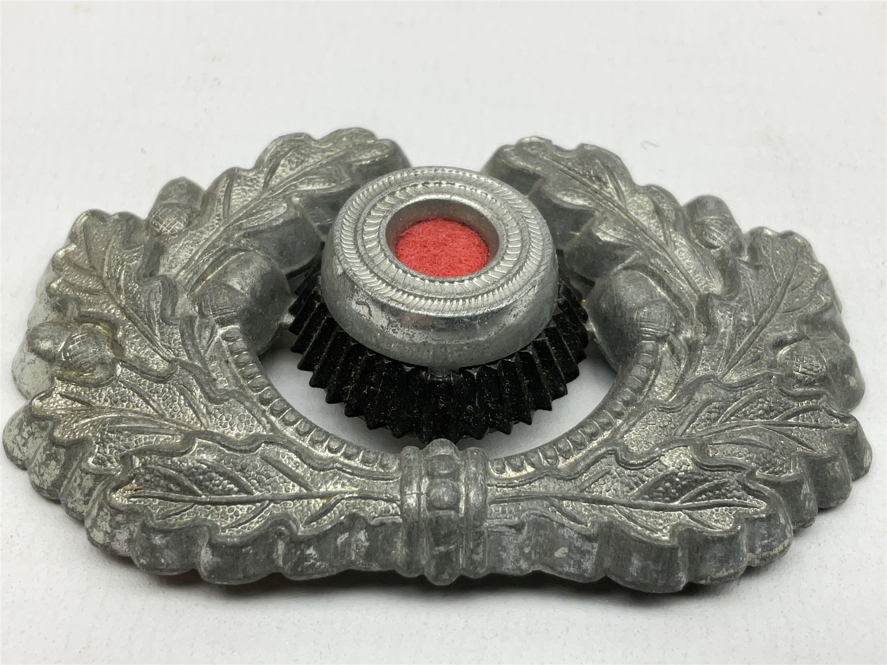 Five WW2 German peaked cap badges, four with double-pinned backs