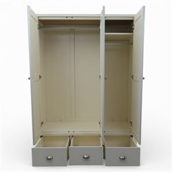 Modern triple wardrobe in white finish with oak moulded top enclosed by three doors with three drawers to base, with metal cup handles raised on bracket feet