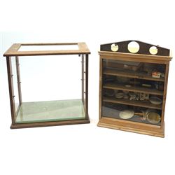 Two Vintage display cabinets, including a counter top example with four glazed panels, and a glazed front wall example. 