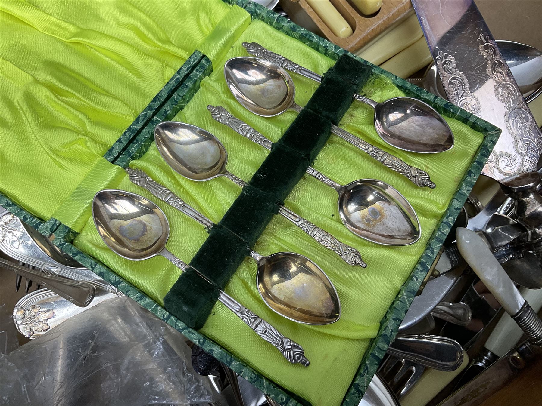 Set of four hallmarked silver teaspoons modelled on spoons from the Roman Imperial period, silver fork, and quantity of silver plated and other cutlery to include Walker & Hall, in two boxes