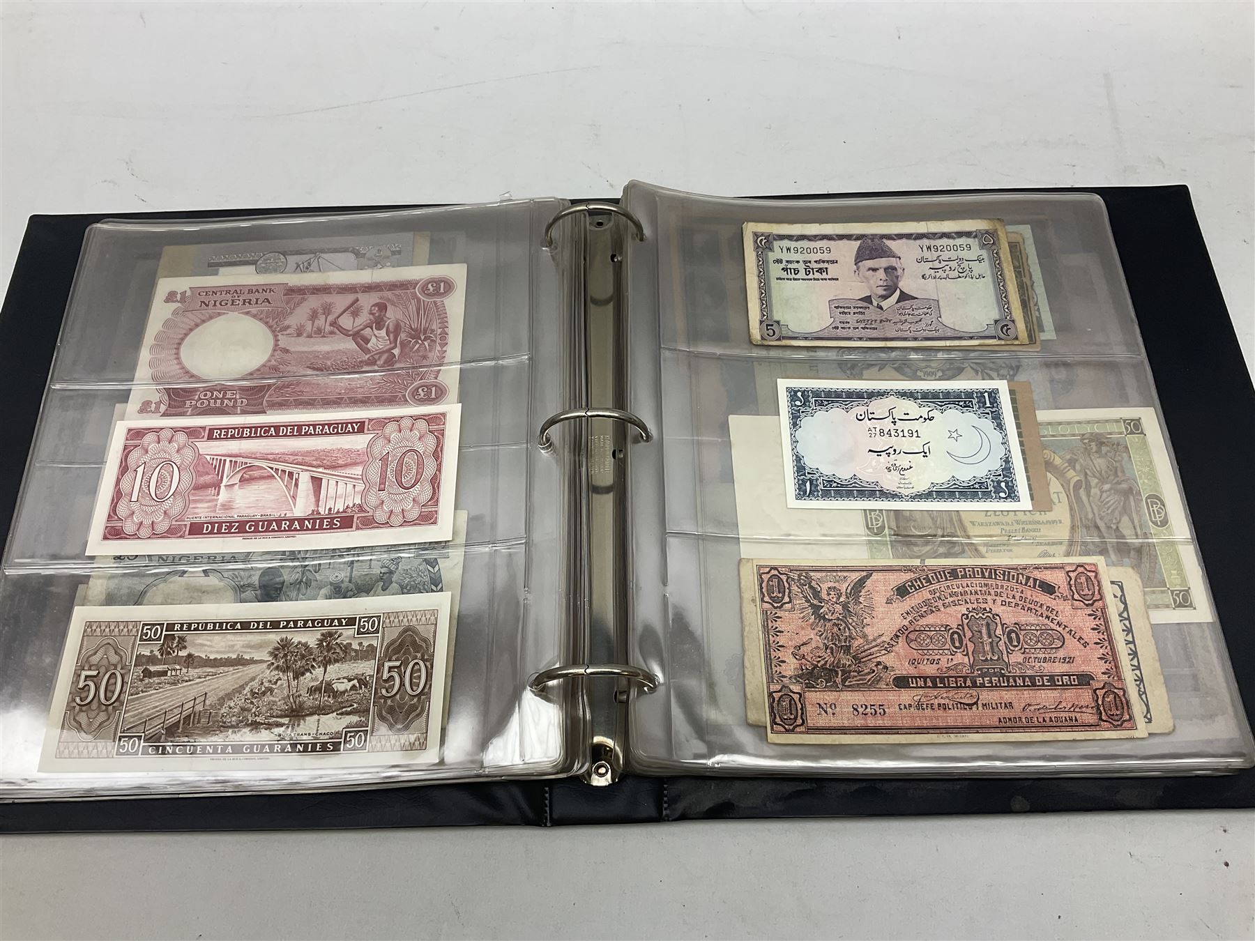 World banknotes, including Queen Elizabeth II The States of Jersey one pound 'DB202703', five pounds 'BB527762' and ten pounds 'AB651481', reserve bank of New Zealand two dollars '1L3 741894', King George V Straits Settlements one dollar 1st January 1935 'F/83 28924', various Bank of England notes etc, housed in two ring binder albums