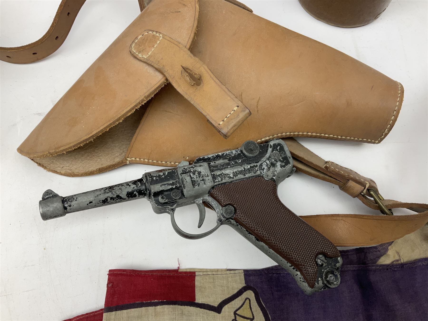 George VI 1937 Coronation flag, the central portrait and date covered with stitched panels 56 x 83cm; sailor's hat; leather holster with belt dated 1943 containing Lone Star toy die-cast Luger gun; and reproduction Stanley brass cased pocket sextant (4)