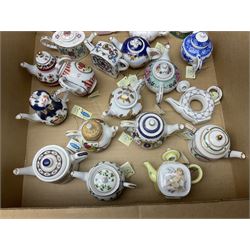 Twenty seven Porcelain Art miniature teapots, with wooden display together with a collection of other ceramics and glassware etc, including Goebel Hummel collectors plates, in three boxes,