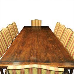 Royal Oak Furniture Co - Jacobean style oak dining table with suite of ten oak high back dining chairs (8+2), rectangular plank top dining table with moulded edge above carved frieze, raised on bulbous turned supports united by stretchers, together with a set of oak framed high back dining chairs including two carvers, upholstered in striped fabric with studded borders, on turned supports united by stretchers 