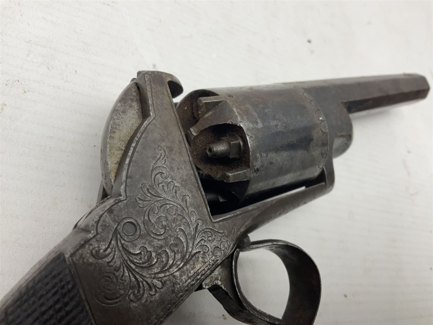 Mid-19th century Smith London .36 cal. transitional five-shot percussion revolver, the 12cm rifled octagonal barrel with side loading lever, side safety, some engraved decoration and chequered two-piece grip L28cm overall