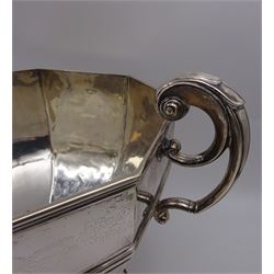 Large Edwardian silver trophy cup, of octagonal waisted form, the body with personal engraving, with twin capped bifurcated scroll handles, upon conforming octagonal stepped foot, hallmarked William Hutton & Sons Ltd, London 1908, H22.5cm