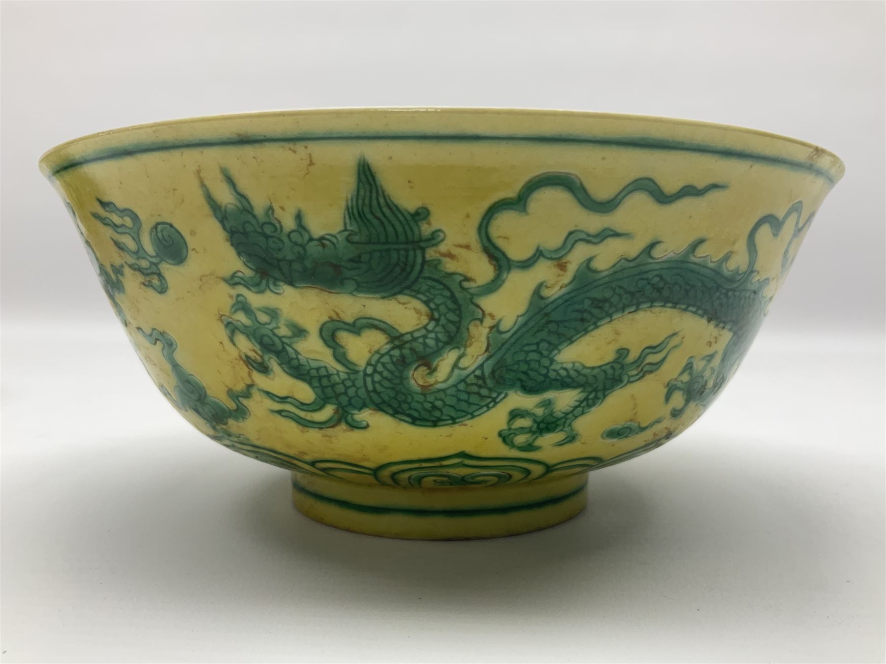 Pair of Chinese famille jaune bowls, decorated in green enamel with a dragon chasing a flaming pearl amongst clouds, upon a yellow ground, the interior decorated to centre with dragon, with six character mark beneath, D17.5cm