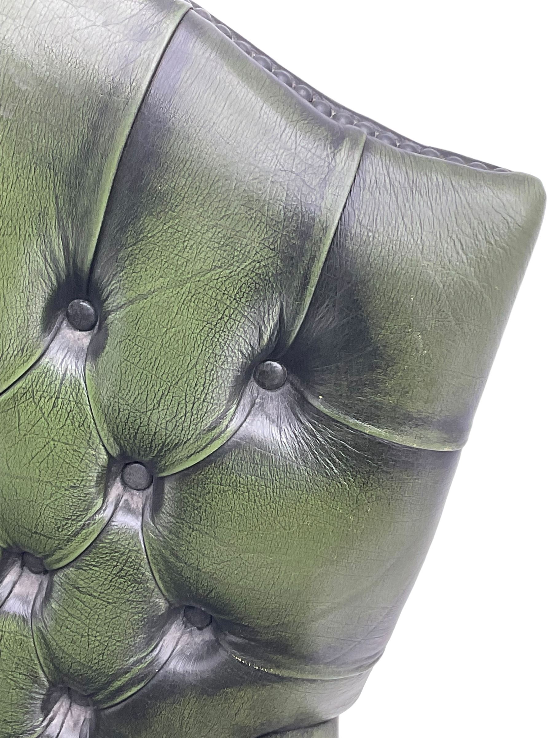 Georgian design swivel office desk chair, upholstered in buttoned green leather, on five spoke base with castors 