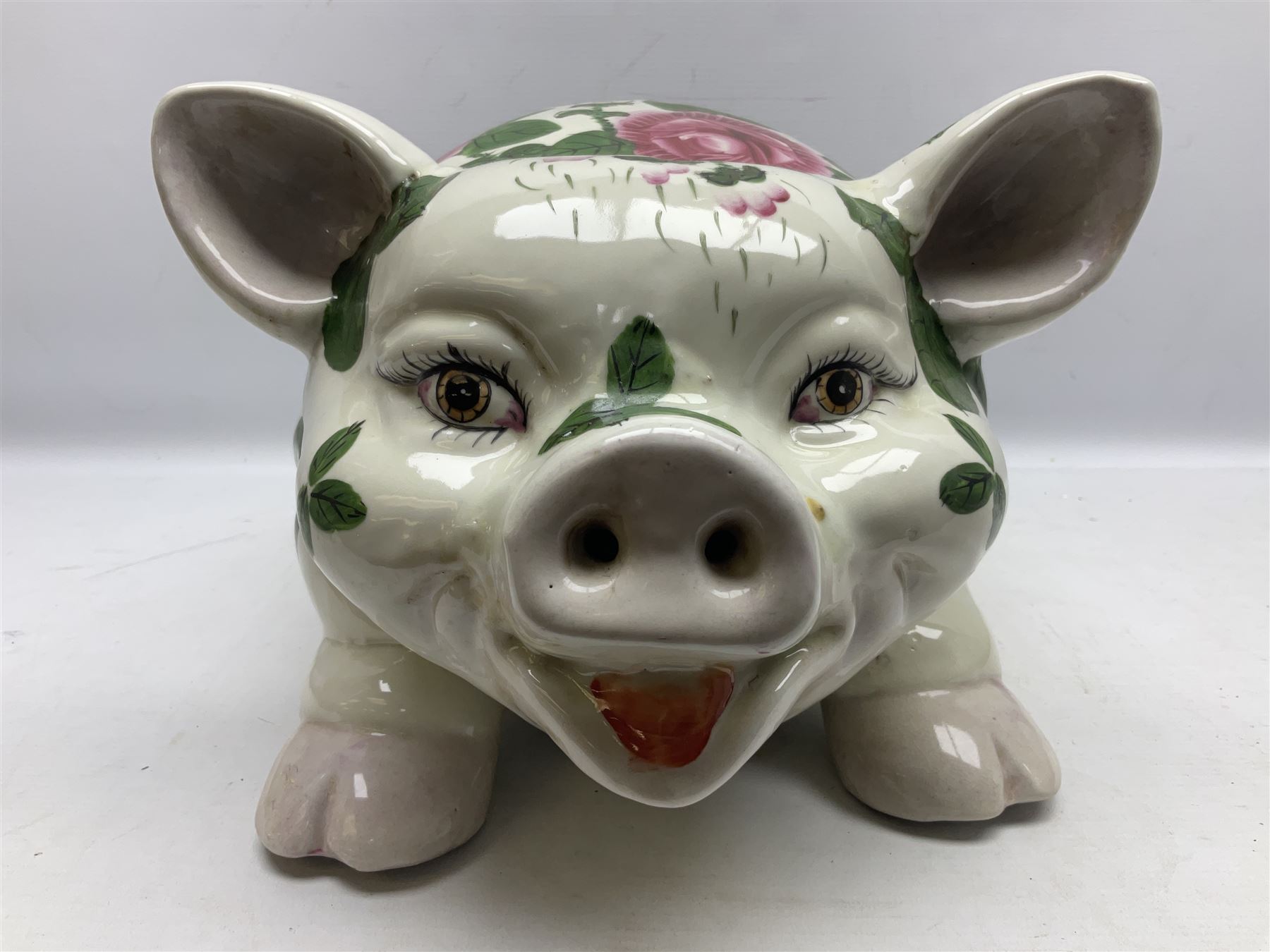 Large ceramic figure of a pig decorated with roses, L45cm