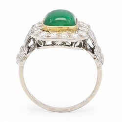 18ct white gold and platinum emerald and diamond cluster ring, single octagonal cabochon cut emerald, surrounded by sixteen milgrain set round cut diamonds, the shoulders set with baguette and single cut diamonds, stamped 18ct, total diamond weight approx 1.55 carat
