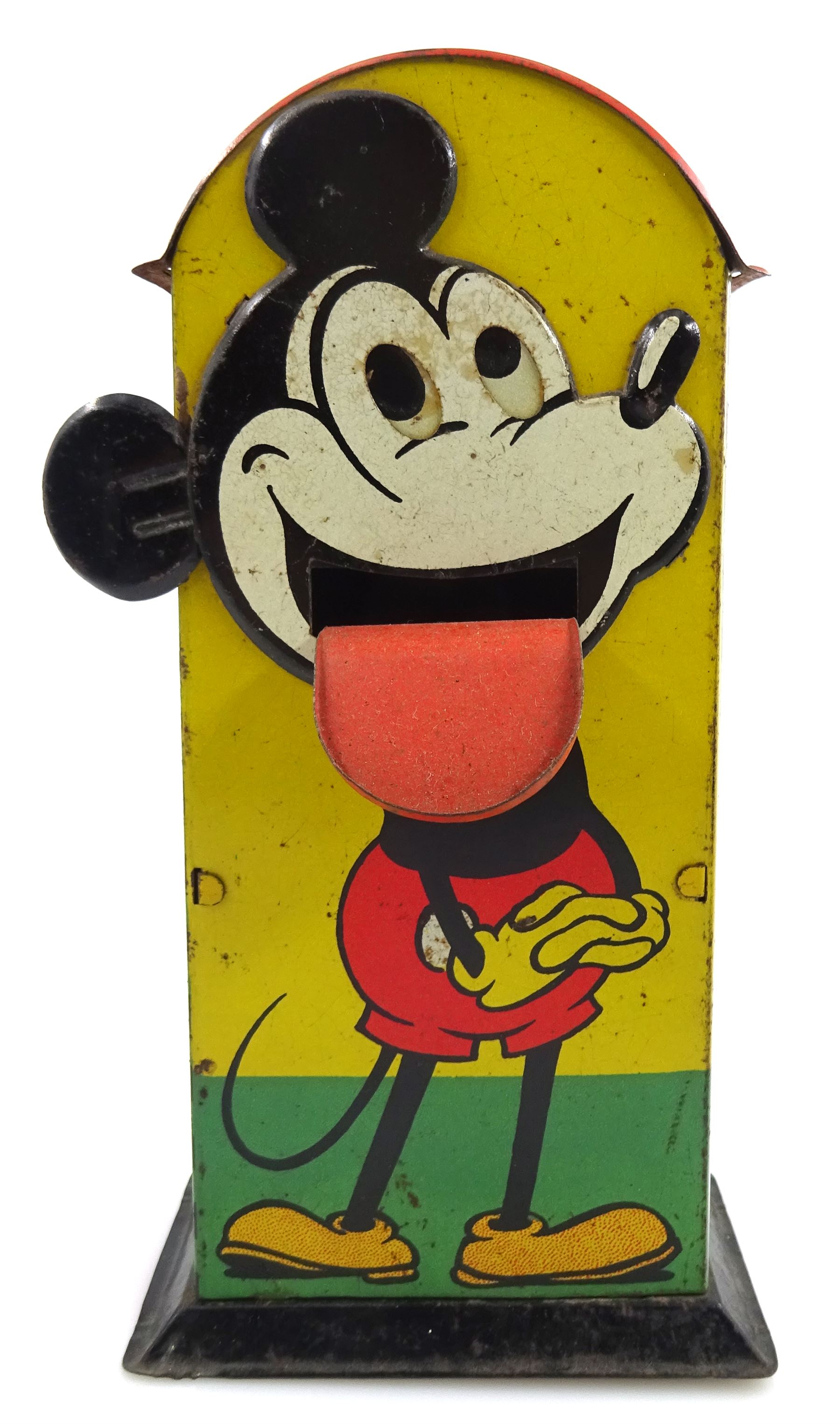 Saalheimer & Strauss Germany 'Smile Please' Mickey Mouse mechanical tin-plate money bank, Type I, depicting Mickey posing with folded hands on the front and as a photographer with a camera tripod on the reverse along with the motto 'If you only pull my ear you will see my tongue appear. Place a coin upon my tongue save your money while you're young'. H17.5cm