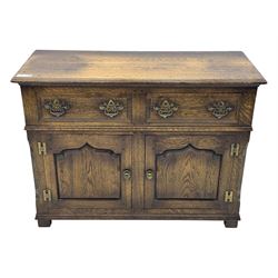 Early 20th century Jacobean design oak dresser sideboard, rectangular top with moulded edge over two baize-lined drawers with pierced handles, above two fielded panel cupboard doors, on stile supports