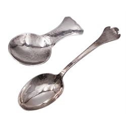 Two modern Arts and Crafts style silver spoons both by Guild of Handicraft, the first example a caddy spoon with hammered finish, L8.2cm, hallmarked Guild of Handicraft, London 1975, the second example a Trefid tea spoon with rat tail bowl, L14cm, hallmarked Guild of Handicraft, London 1985, approximate total weight 1.7 ozt (53 grams)