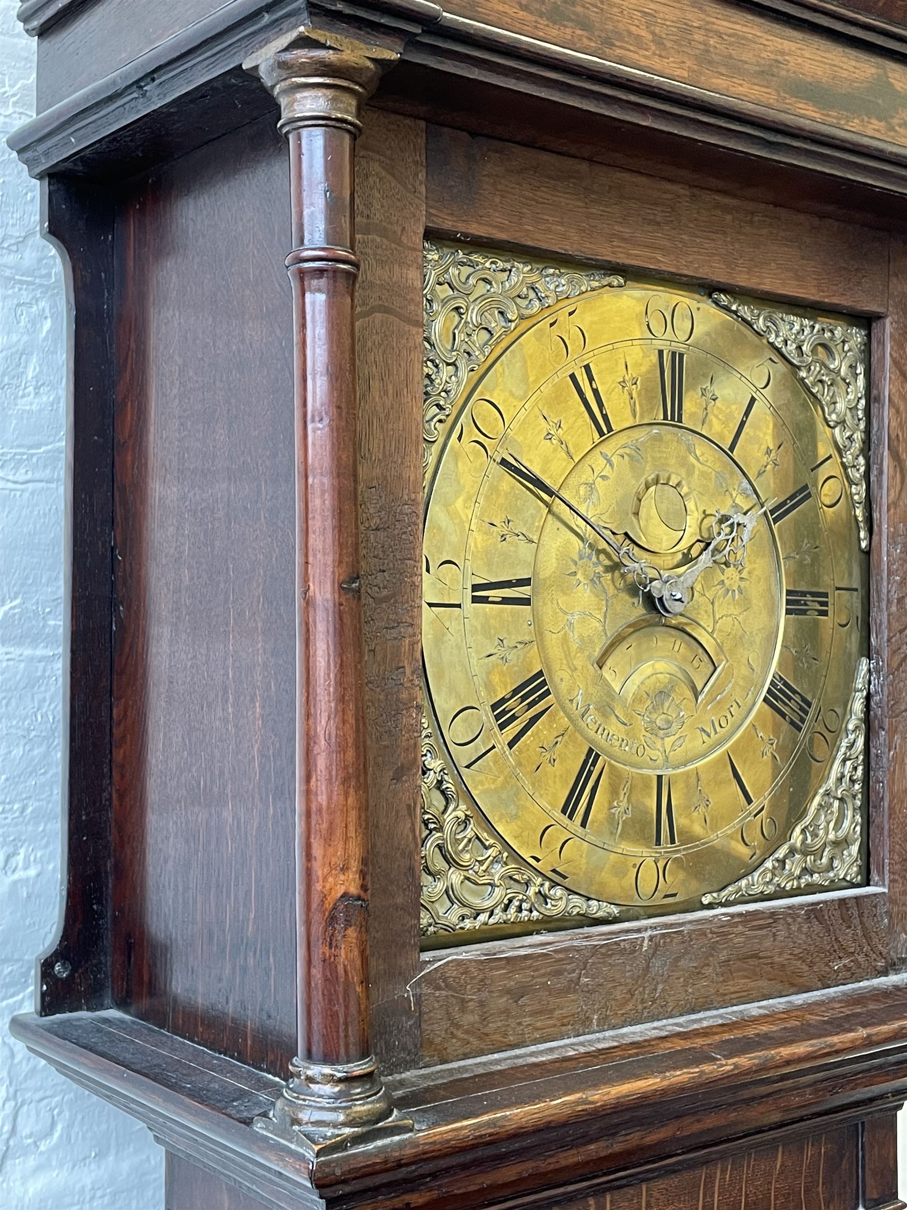 18th century c1760 oak cased George III longcase clock by William Eastwood of Burnley, with a stepped caddy top on a projecting cornice and blind frieze, square glazed door flanked by two turned pillars with gesso capitals, trunk with conforming recessed pillars and a full length wavy topped door, on a square plinth with a raised panel and shaped skirting, 12” square brass dial, 11” chapter ring with Roman numerals and five-minute Arabic's,  