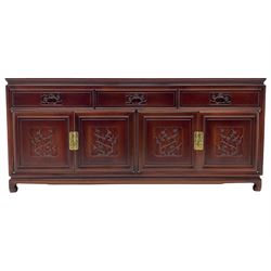 Chinese hardwood sideboard, three drawers above four cupboards, the doors relief carved with flowers and birds 