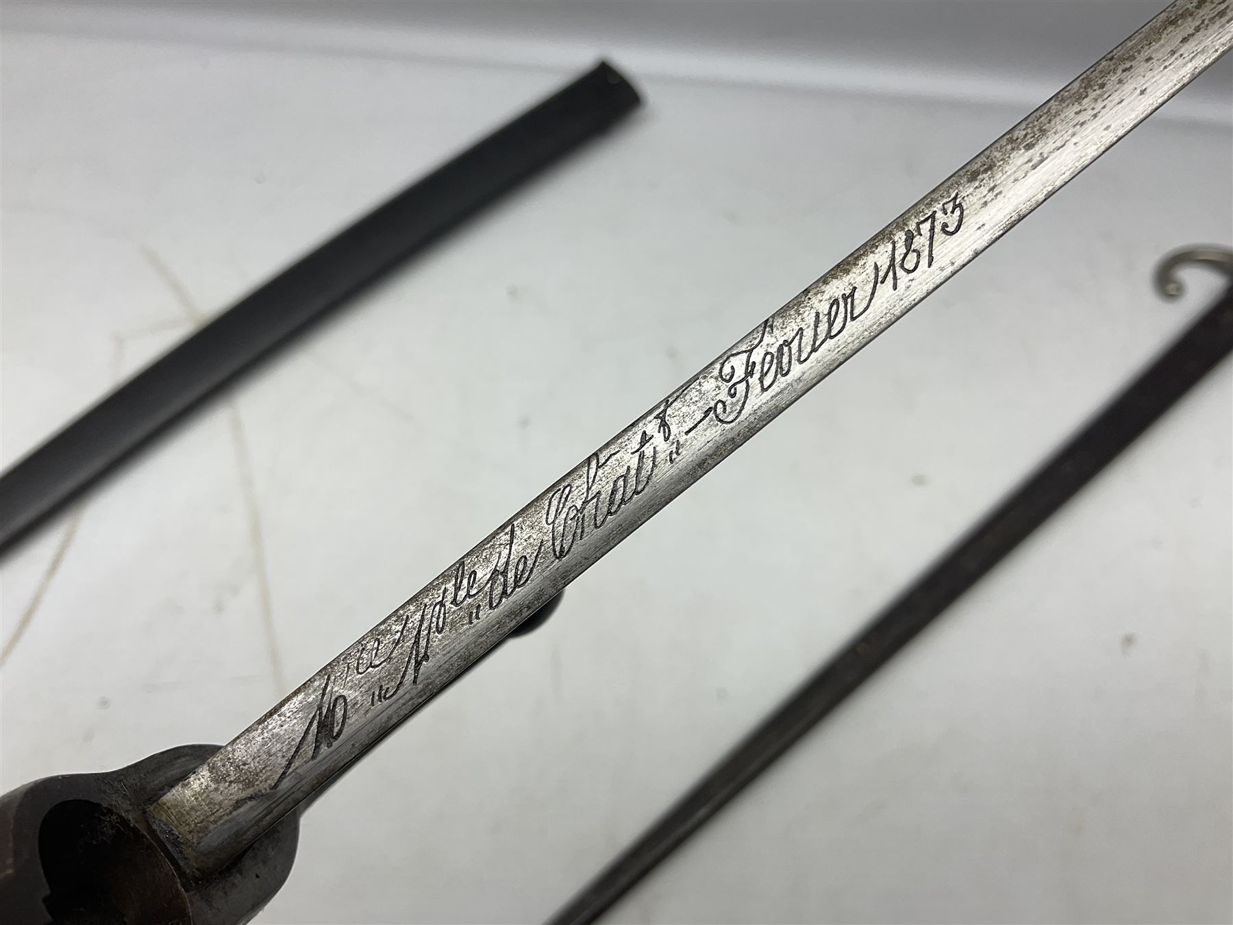 French Model 1866 Chassepot bayonet with 57cm curving fullered steel blade dated 1873 No.L63963; in steel scabbard with conforming number L71.5cm overall; and French St. Etienne Gras bayonet dated 1878 No.K10674 in steel scabbard numbered 79437 (2)