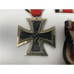 WWII German Iron Cross 2nd Class, the suspension ring stamped 128 for S. Jablonski G.m.b.H. Posen; with ribbon; together with an embroidered cloth eagle badge and quantity of German medal ribbons.