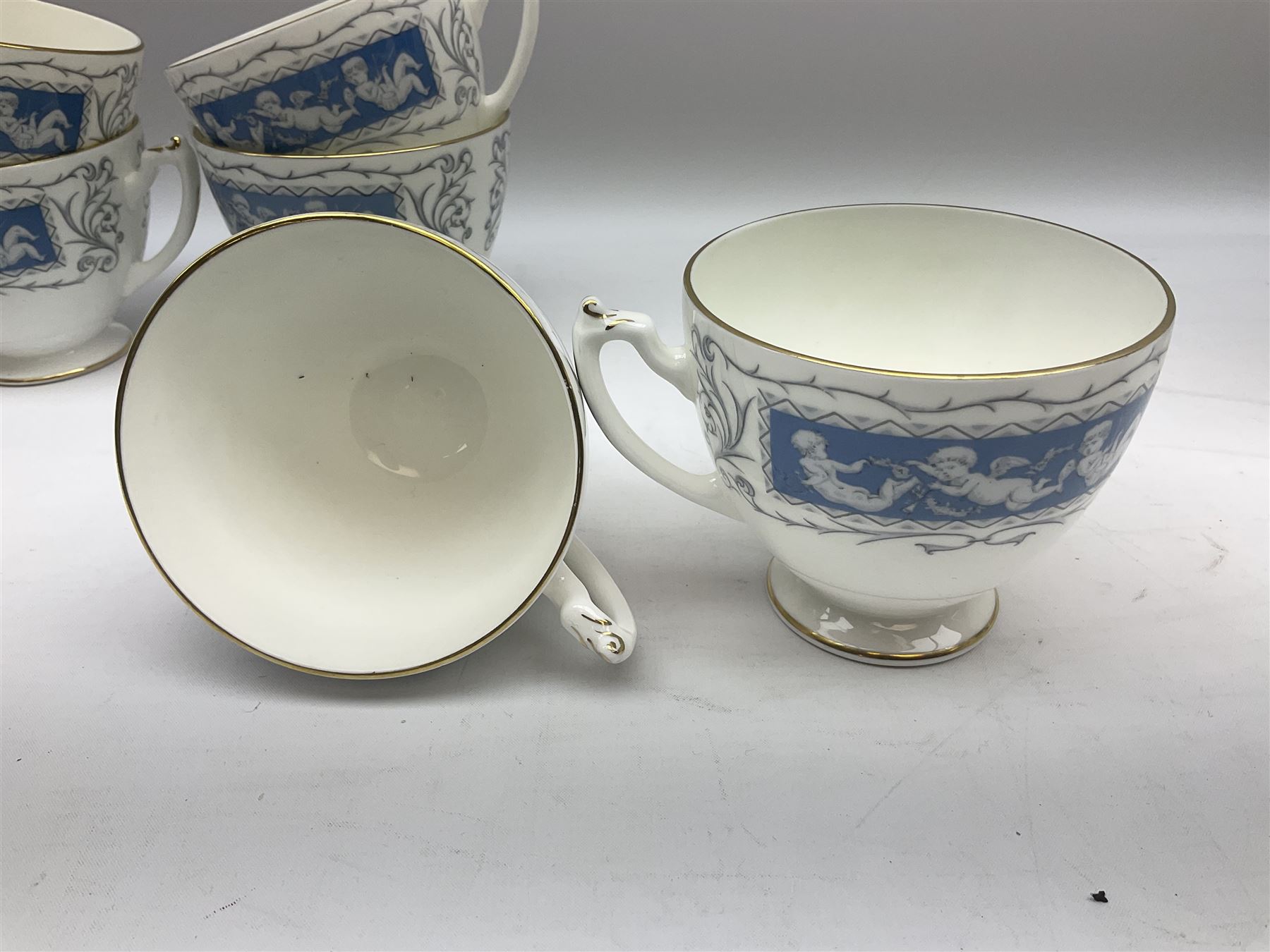 Coalport Revelry pattern tea and dinner wares, comprising nine dinner plates, four salad plates, eleven side plates, sauce boat and stand, ten teacups and ten saucers, and preserve pot and cover, together with a Coalport plate of shaped form decorated with pink roses, and a Royal Crown Derby Royal Antoinette pattern trio