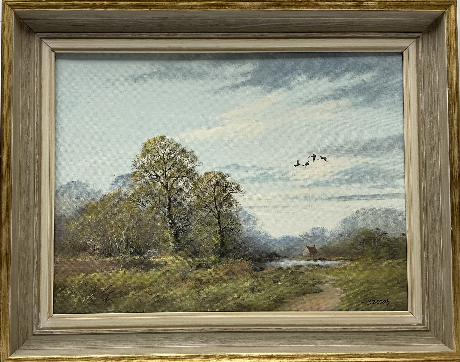 John Caesar Smith (British 1930-): Wooded Landscape with Geese in Flight, oil on canvas signed 29cm x 39cm