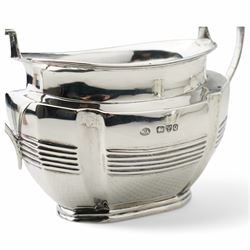 Late Victorian silver three piece tea set of panel sided oval design, the teapot with ebonised handle and lift, Chester 1898/99 Maker Florence Warden and William Aitken