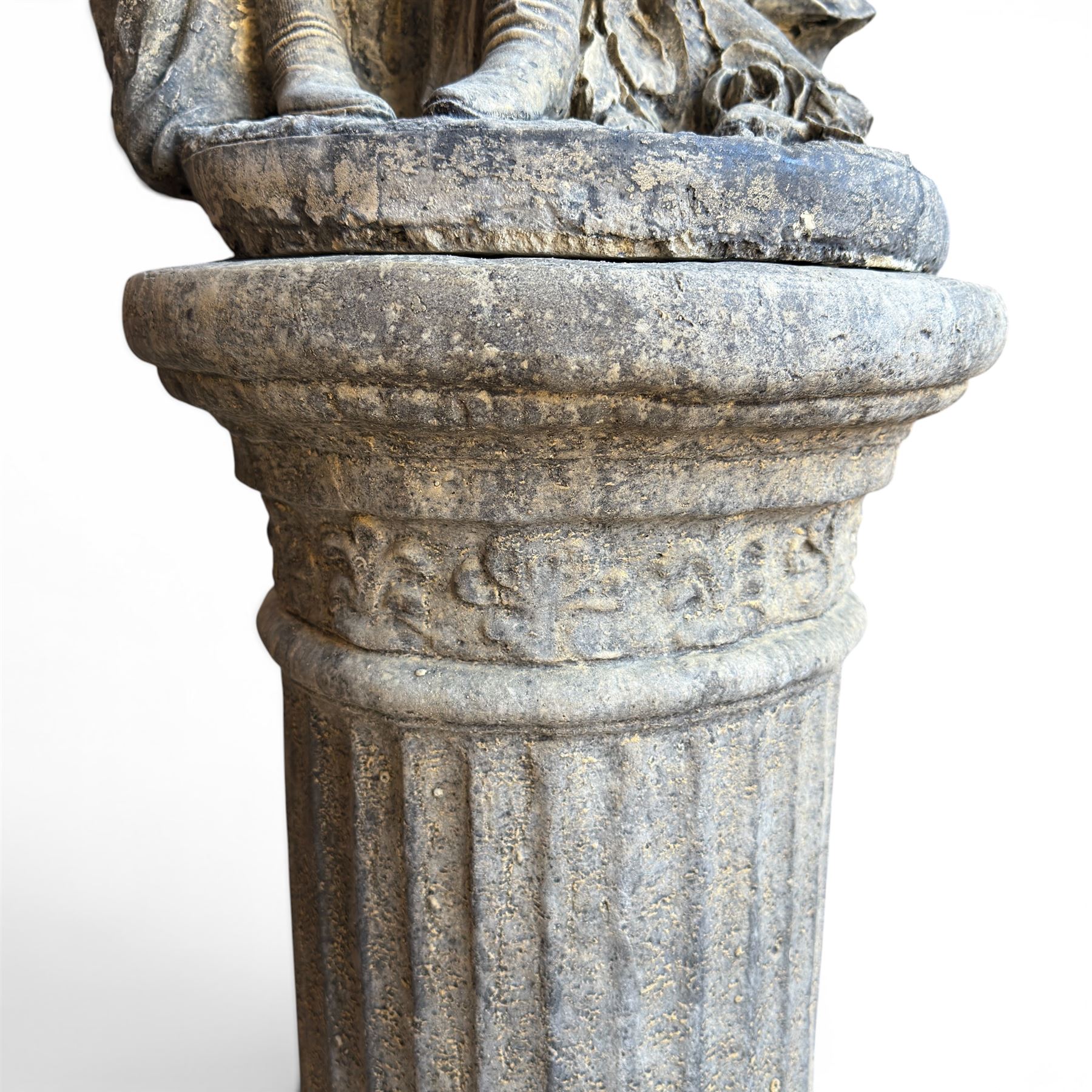 Composite garden statue group of Romeo and Juliet embracing, the couple adorned in Medieval dress standing on a naturalistic base with fallen flowers, raised on a Neoclassical fluted pedestal with Anthemion leaf motifs