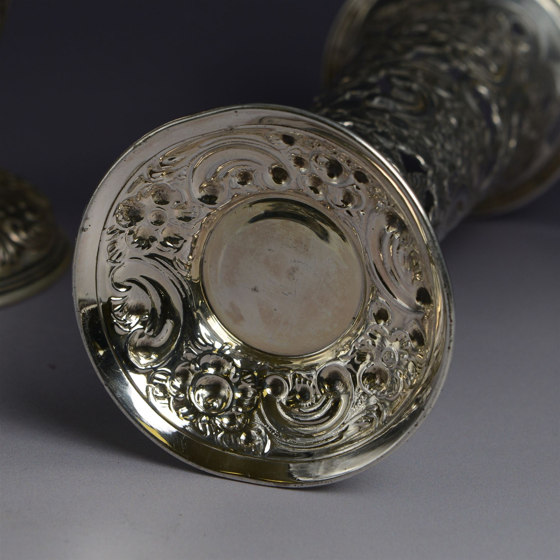 Three late 19th century/early 20th century silver vases, of trumpet form, all embossed with floral and foliate decoration, one example with weighted base, all hallmarked, tallest H18cm