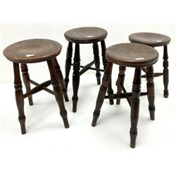 Four country wood stools, turned supports joined by stretchers