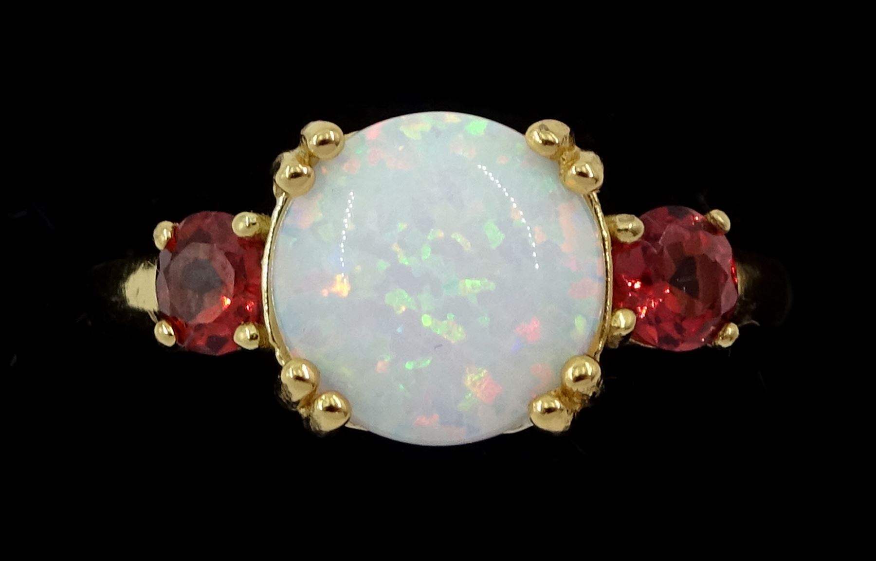 Silver-gilt three stone opal and garnet ring, stamped 925