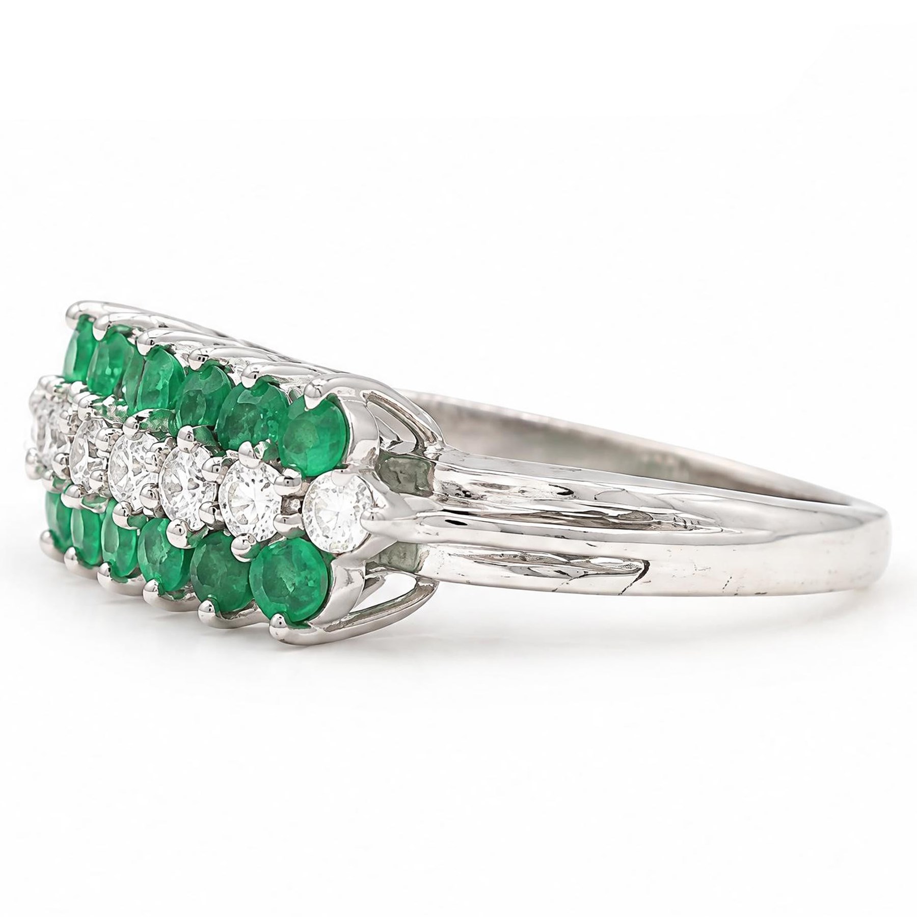 18ct white gold three row diamond and emerald ring, set with eight round brilliant cut diamonds and a row of seven emeralds set either side, total diamond weight approx 0.30 carat