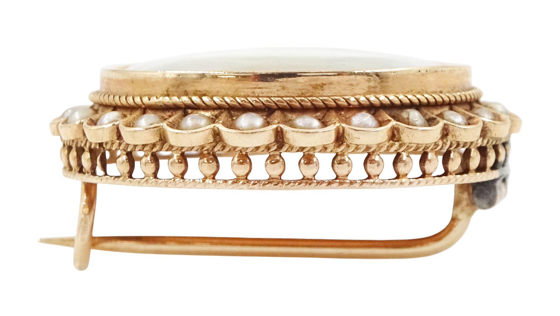 19th century gold pearl portrait brooch, set with a circular miniature of a woman in 18th century dress on ivory, under a glazed panel, with split pearl surround, to a pierced scalloped gallery. This lot has been registered for sale under Section 10 of the APHA Ivory Act