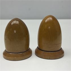 Six sewing related Mauchline ware comprising an oval reel box with internal label for Clark & Co's, tape measure, pin case and three thimble holders of ovoid form 