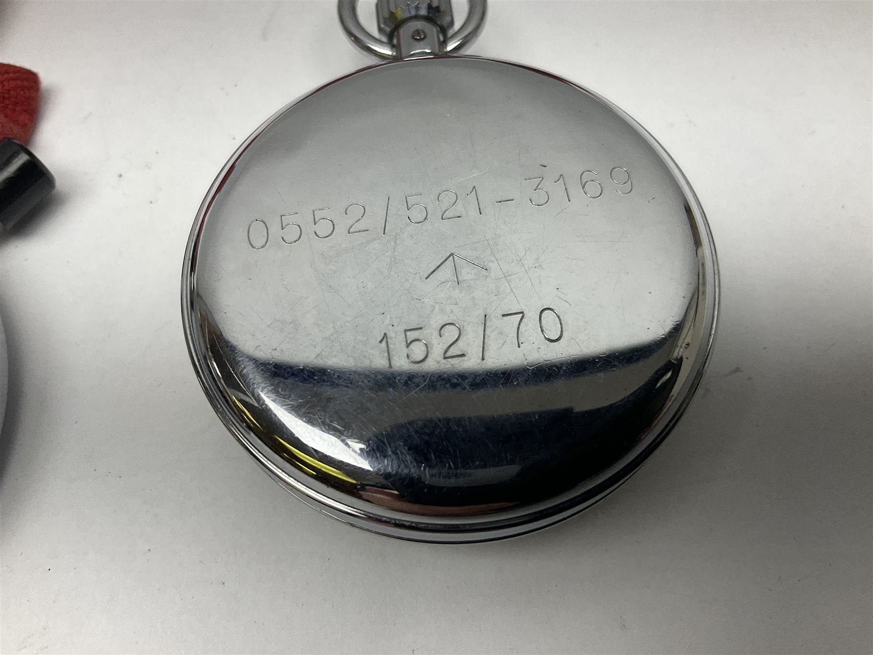 Nero Lemania - Royal Air Force type military stopwatch, outer black register for 60 seconds with 1/5th seconds divisions, inner red register to 100 with 1/10 divisions, subsidiary dial recording to 30 minutes, signed and marked with Broad Arrow, case back engraved '0552/521-3169' Broad Arrow '152/70'; together with a Balmaster Antichoc 1/10 4 Rubis stopwatch (2)