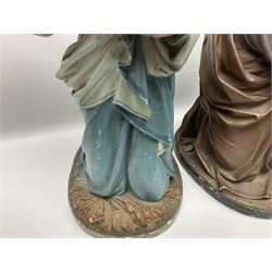 Two religious painted plaster figures of Mary and Joseph kneeling on oval plinths, with impressed mark 'Raffl et Cie Paris', H60cm 