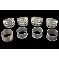 Set of four Edwardian silver napkin rings, pierced and embossed flower decoration by Walker & Hall, Sheffield 1910 and four other silver napkin rings, hallmarked, approx 6.9oz