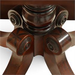 Regency figured mahogany breakfast table, figured rectangular tilt-top with rounded corners and rosewood banding, on turned column with four out-splayed supports with brass cups and castors 