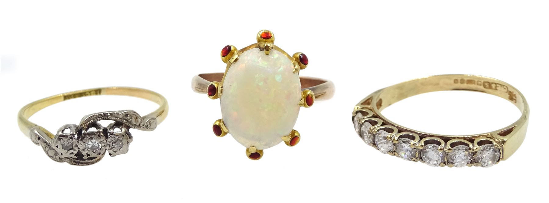 Gold three stone diamond ring, with diamond set shoulders, stamped 18c t& Pt, gold seven stone cubic zircoinia ring and a rose gold opal ring, both hallmarked 9ct