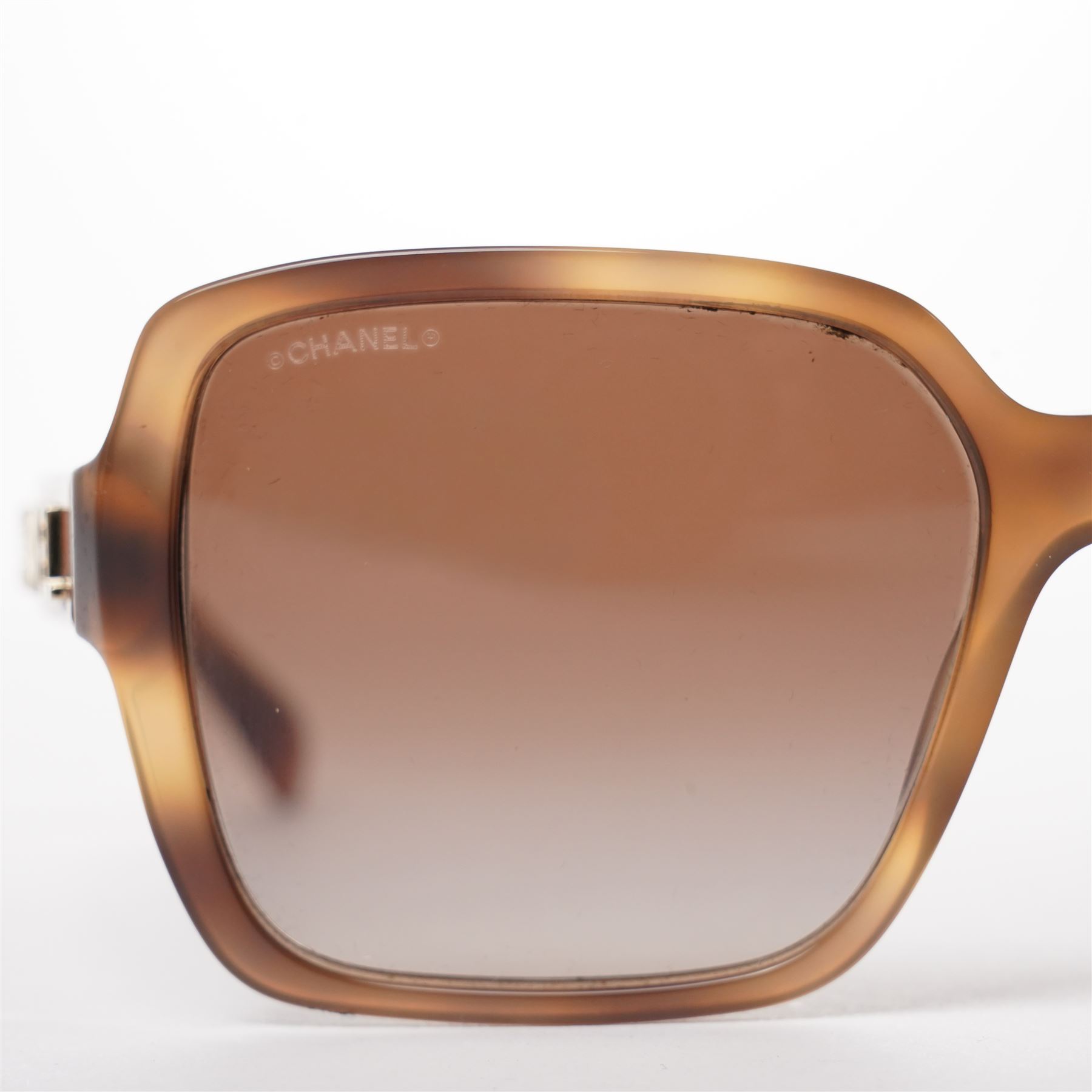 Chanel - pair of oversized sunglasses, with translucent tortoiseshell-effect brown acetate frames and gradient tinted lenses, the arms boldly set with gold-tone ‘CHANEL’ lettering, with original quilted leather case, booklet and box