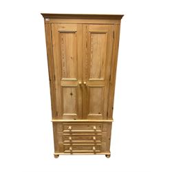 Traditional pine double wardrobe, fitted with two panelled doors enclosing hanging rail, over three drawers, flanked by fluted uprights