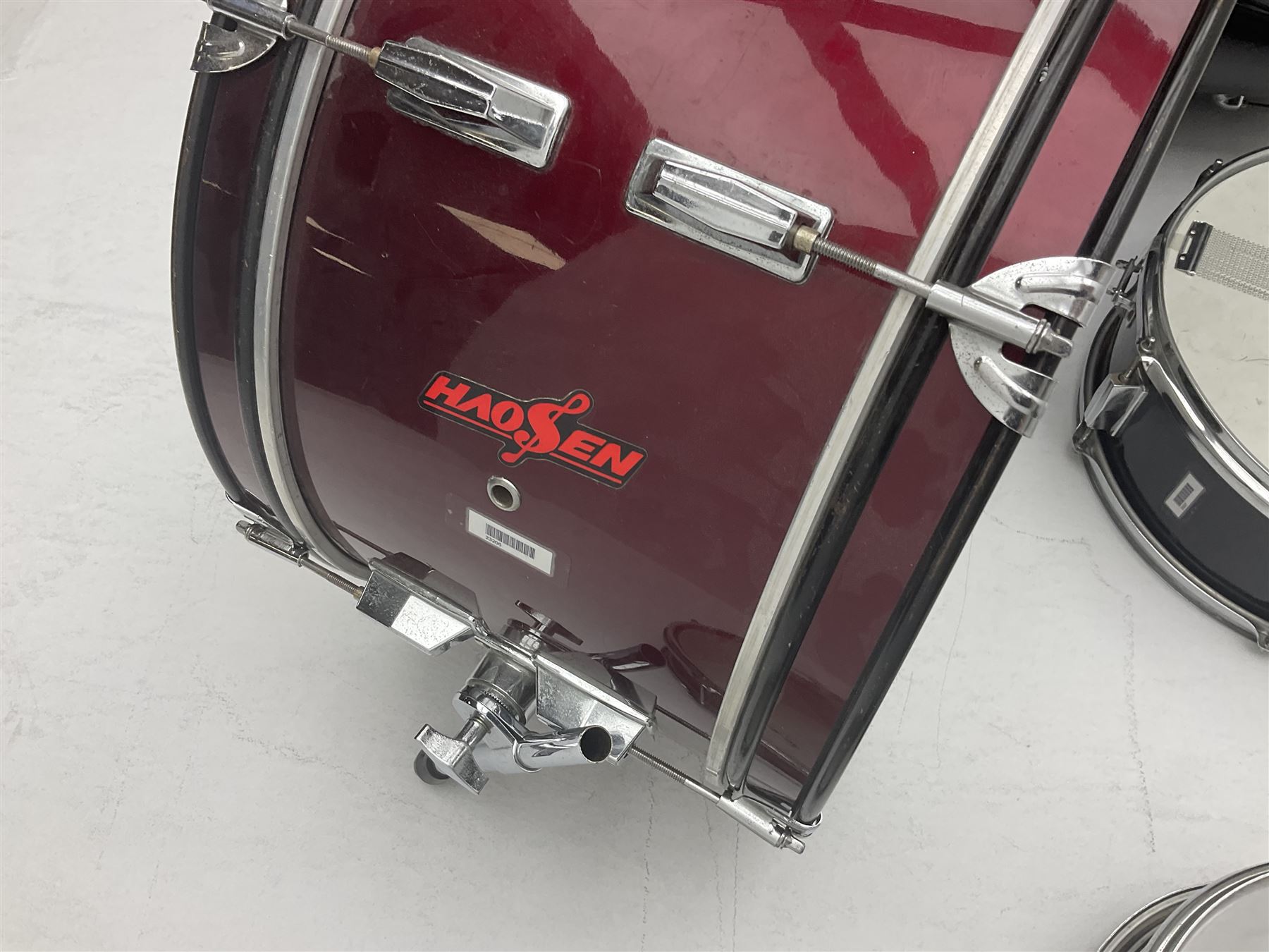 Rockburn eight-piece black drum kit with bass drum, floor tom and five other toms and snare drum; together with two other snare drums; Haosen bass drum; four cymbals; various stands, foot pedals, stool, tri-angle, drum sticks etc