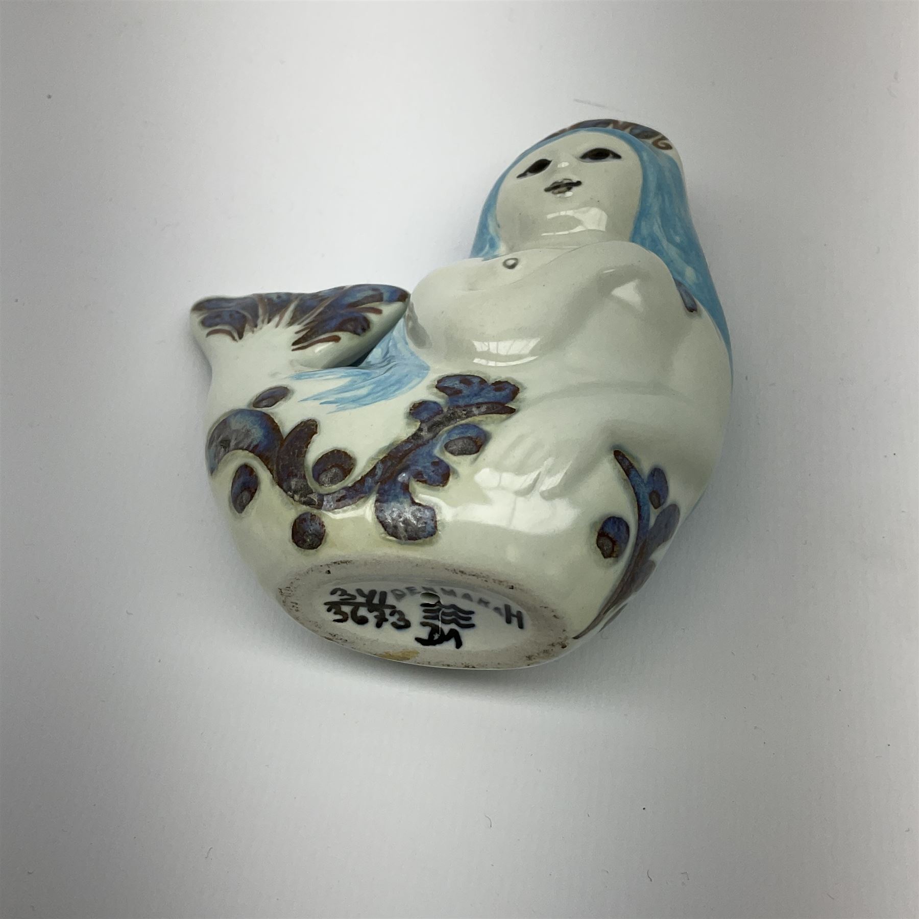 A Doreen Middelboe for Royal Copenhagen Aluminia figure, modelled as a mermaid, with printed and painted marks beneath, H10.5cm.