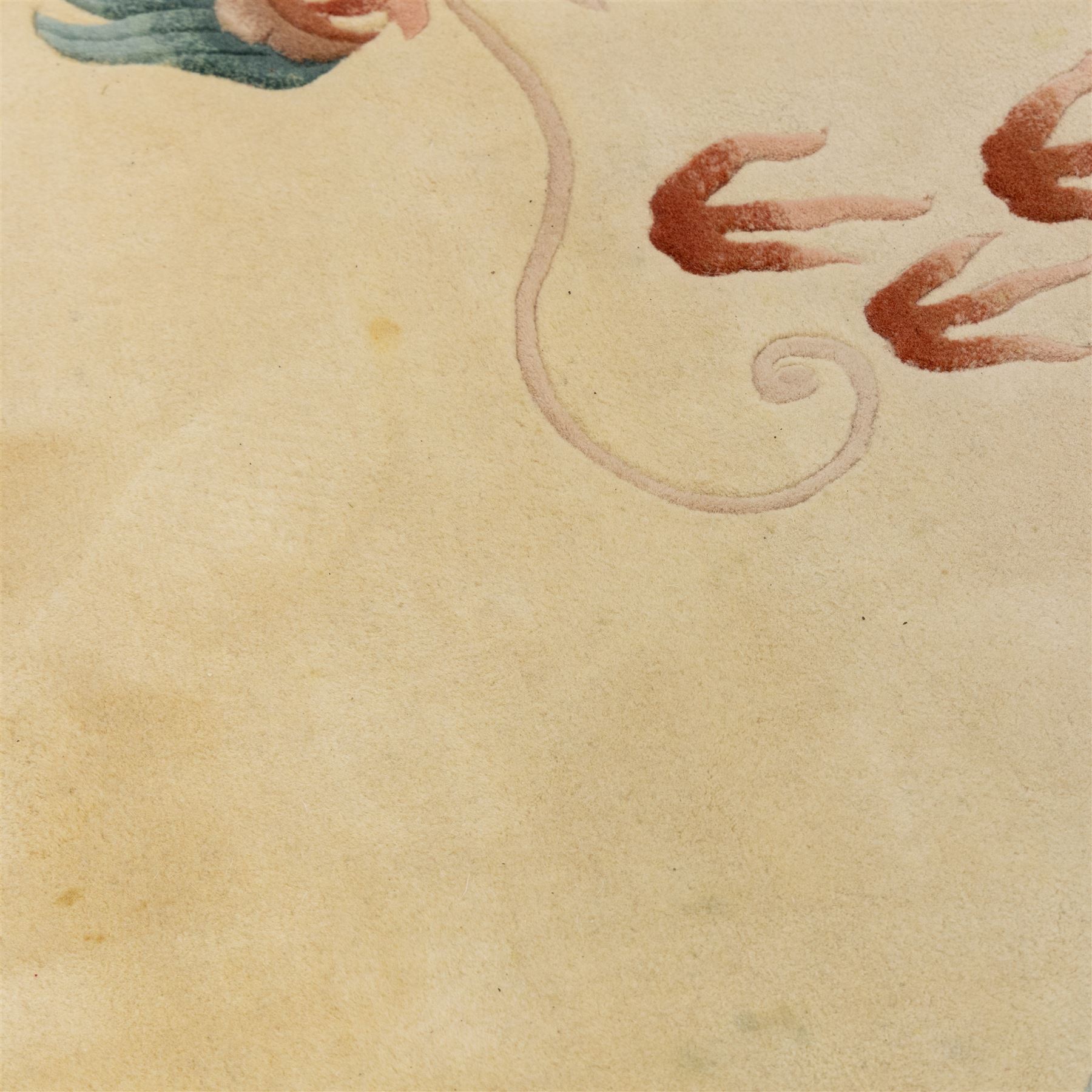 Late 20th century Chinese wool carpet, cream field with five stylized dragons arranged in a circular formation around a central flaming pearl motif, dragons depicted with elongated bodies and clawed feet amongst stylized cloud forms, enclosed within a narrow inner border and a wider outer border decorated with traditional Chinese motifs and symbols