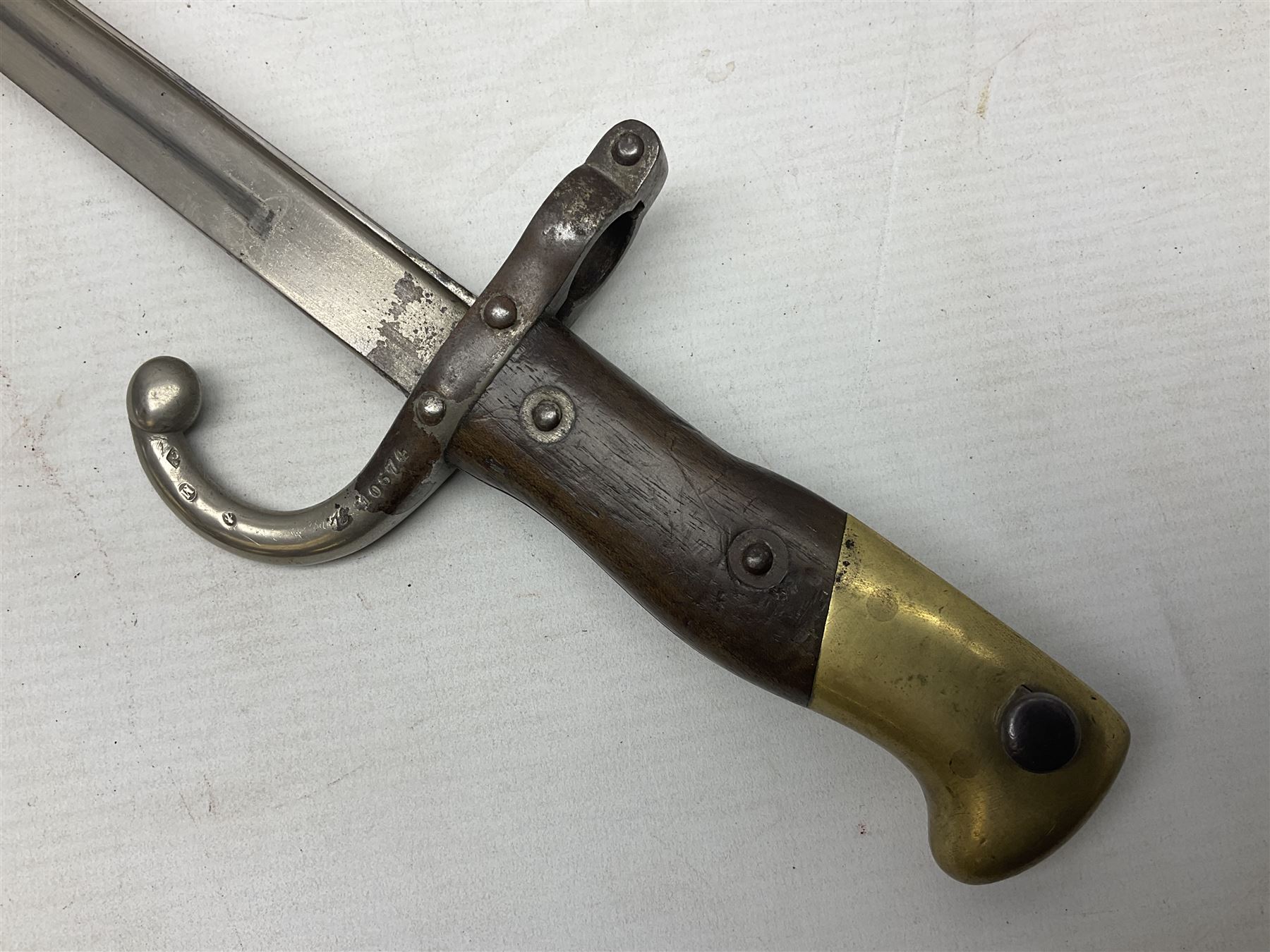 French Model 1866 Chassepot bayonet with 57cm curving fullered steel blade dated 1873 No.L63963; in steel scabbard with conforming number L71.5cm overall; and French St. Etienne Gras bayonet dated 1878 No.K10674 in steel scabbard numbered 79437 (2)